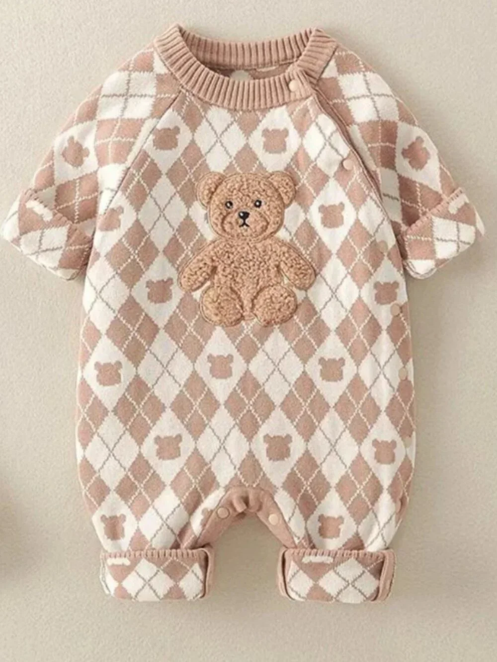 Cozy neutral baby romper with argyle knit pattern and 3D teddy bear applique